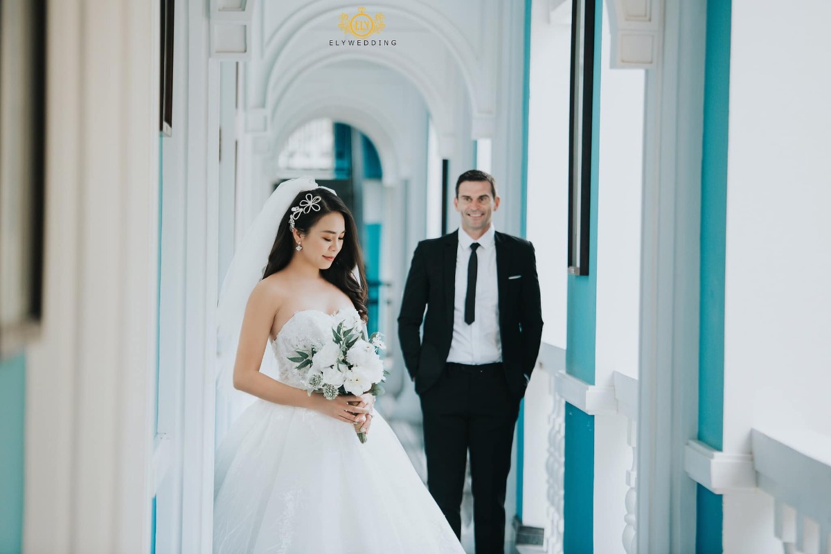 Chuyện tình Việt - Mỹ

Vợ chồng với nhau là duyên số, là định mệnh, có ai tin điều đó ko?

Em đã từng chủ động huỷ hôn vào phút chót, dù đám cưới sắp diễn ra. Lúc đó em đã 33 tuổi. Không nhiều người có đủ dũng cảm để chia tay bạn trai ở cái tuổi đó. Áp lực từ phía gia đình, từ xã hội, ai cũng mong đợi đám cưới ấy diễn ra. Bạn trai cũ của em là người Pháp, có công việc tốt, thu nhập ổn. Hai đứa nhìn đẹp đôi, ai cũng bảo vậy (anh ta cao trên 1,9m, còn em 1,73m). Tuy nhiên càng ngày em càng nhận ra hai đứa có sự khác biệt rất lớn về tính cách và cách sống. Em là người luôn vui vẻ thân thiện với mọi người còn anh ta rất hay phàn nàn và rất dễ nóng giận. Em là người hào phóng, chi tiêu rộng rãi còn anh ta thì lại rất chặt chẽ theo đúng kiểu đàn ông châu Âu. Khi em nói chia tay, anh ta khóc lóc, đau khổ, đêm nào cũng đến đứng trc cửa nhà em tới 2-3 giờ sáng, dù em ko mở cửa, còn đạp xe cả trăm cây số về tận quê em để chứng tỏ tấm chân tình, ngày nào cũng cả trăm tin nhắn, cuộc gọi để năn nỉ...Thế nhưng tính em vốn quyết đoán, đã nói là làm, muốn giũ thì phải phũ. Em nhận ra e k yêu anh ta nhiều. Nếu vẫn cố đám cưới, gia đình em sẽ vui nhưng đổi lại, em k thấy hạnh phúc. Nếu không cưới thì thấy có lỗi với gia đình. Còn cưới thì thấy có lỗi với bản thân. Rồi em cũng quyết định 1 lần dám sống vì bản thân. Vài tháng năn nỉ em quay lại k đc thì cuối cùng anh ta cũng từ bỏ. Cũng nhờ dám bỏ anh ta vào phút chót như vậy, định mệnh đã đưa em gặp chồng em bây giờ, một người đàn ông thành đạt, hào phóng và hết sức yêu chiều vợ.

Càng ngày càng tin vào số phận, mọi thứ như sự sắp đặt của ông trời vậy. Cả anh và em đều ko thích cs hôn nhân. Trc khi gặp nhau, anh vẫn bảo, anh k thích kết hôn, công việc của anh quá bận rộn và anh thấy con cái thật là phiền phức. Lần đầu gặp, hai đứa nói chuyện với nhau quá hợp, cười như ma làm. Đến lúc phải về, bỗng dưng anh hỏi “sau này nếu có kết hôn thì em muốn tổ chức đám cưới ở đâu”. Em chỉ bảo “Marriott Phú Quốc” rồi đi về. Đến lần gặp thứ 2, ăn tối xong, anh tỏ ra cực kì nghiêm túc “anh nghĩ là anh đã sẵn sàng cho cs gia đình. Em có sẵn sàng làm mẹ những đứa con của anh ko?”. Trời ơi, ta nói fast and furious đúng kiểu phim Mỹ. Lúc ấy shock quá, với lại nhanh quá nên bảo cho em thêm thời gian đi. Lúc tiễn anh ra máy bay về lại châu Âu, anh lại bảo “anh muốn được sống cùng em phần đời còn lại. Bất cứ khi nào em muốn sang Ireland thăm anh, hãy nói với anh, anh sẽ mua vé cho em”. Rồi anh đi, vừa qua cửa an ninh, đã thấy tin nhắn của anh. Anh nói anh muốn khóc vì lần đầu tiên anh cảm thấy hụt hẫng vì phải xa 1 người, “anh nhận ra anh cần em biết bao nhiêu”. Rồi từ đó, hai đứa bắt đầu yêu xa. Anh người Mỹ nhưng đag làm dự án ở châu Âu. Giáng sinh vừa rồi, anh muốn đưa em về ra mắt bố mẹ. Tuy nhiên, phút chót, em bị từ chối visa Mỹ mặc dù lịch sử du lịch tốt (hộ chiếu đi 26 nước), tài chính tốt. Tới lúc đó, cay cú quá mới bảo “thôi mình cưới đi”. Thế là anh mừng lắm, anh bảo “cả gia đình anh và bạn bè đều quá shock khi biết anh sắp kết hôn”. Giờ lại thấy cần phải cảm ơn cô viên chức Mỹ vì đã đánh trượt visa, nếu ko sẽ chẳng có động lực để kết hôn đâu.

Cho tới giờ, đôi lúc vẫn ngỡ ngàng, ko nghĩ sẽ có ngày trở thành cô dâu. Mọi người thường bảo, mọi cô gái đều mong muốn khoác lên mình chiếc áo cưới, có lẽ điều này k đúng lắm với em. Người thân hay bạn bè thân thiết với em đều hiểu em là đứa rất sợ cs hôn nhân và gần như trong đầu k hề có ý tưởng sẽ lấy chồng.Em vẫn từng nói, nếu có ngày em cưới, thì đó k phải là điều e muốn mà đơn giản chỉ là muốn cho bố mẹ e vui. Em là đứa có tính cách ngông cuồng, luôn làm điều mình muốn, luôn đi ngược định kiến và những giá trị xã hội đã lỗi thời. Thế nhưng có 1 điều k thể làm đc, đó là: Ko thể làm bố mẹ buồn. Người ta nói “dao sắc k gọt đc chuôi” là vậy. Cuộc đời con người chỉ có 2 món nợ lớn nhất: 1 là với người sinh ra mình, 2 là với người mình sinh ra. Chừng nào em còn chưa lập gđ, khi ấy bố mẹ e còn chưa yên tâm, dù rằng cs vật chất và tinh thần của e đều đầy đủ. Rồi bỗng 1 ngày, con bạn thân kể về sự ra đi đột ngột của bố bạn ấy, bỗng chợt nghĩ “bố mẹ mình cũng già rồi, chẳng biết họ còn sống đv bao lâu nữa, nếu có thể làm cho họ vui thì tại sao lại ko cố gắng”. Vậy là đồng ý cưới. Đc cái anh chồng cũng hiểu tính nên rất chiều, mọi giấy tờ anh tự tìm hiểu và tự chuẩn bị mọi thứ. Chừng nào em vẫn chưa kí vào giấy là anh vẫn lo em sẽ đổi ý. Cuối cùng thì sau gần 2 tháng lo giấy tờ, thủ tục, hai đứa cũng có đc giấy đăng kí kết hôn và giờ em đang mang bầu đứa con đầu lòng ở tuổi 34.

Thế nên phụ nữ cứ đẹp, tự tin và kiêu hãnh lên nhé. Ở đâu đó luôn có 1 người đang chờ đợi chúng ta. “Standing alone doesn’t mean that i’m alone. It means i’m strong enough to handle everything by myself”. Đúng người, đúng thời điểm mới là quan trọng. Và đừng ngại bắt đầu lại khi thấy mối quan hệ đó ko ổn. Suy cho cùng, đích đến của chúng ta là HẠNH PHÚC. Trong một mối quan hệ, bất cứ khi nào bạn thấy không ổn có nghĩa rằng nó không ổn. Hãy tin vào cảm giác của mình.

P/s: Đây là hình cưới của bọn em chụp tại Ireland và Phú Quốc. Hôm chụp ở Ireland, thời tiết ngoài trời là 2oC (feel like -2oC) nên chỉ chụp vội đc vài tấm, lạnh cóng k cười nổi luôn.
Em 34, anh 44, cả hai đều kết hôn lần đầu.

Nguồn: Lyly Ha Nguyễn