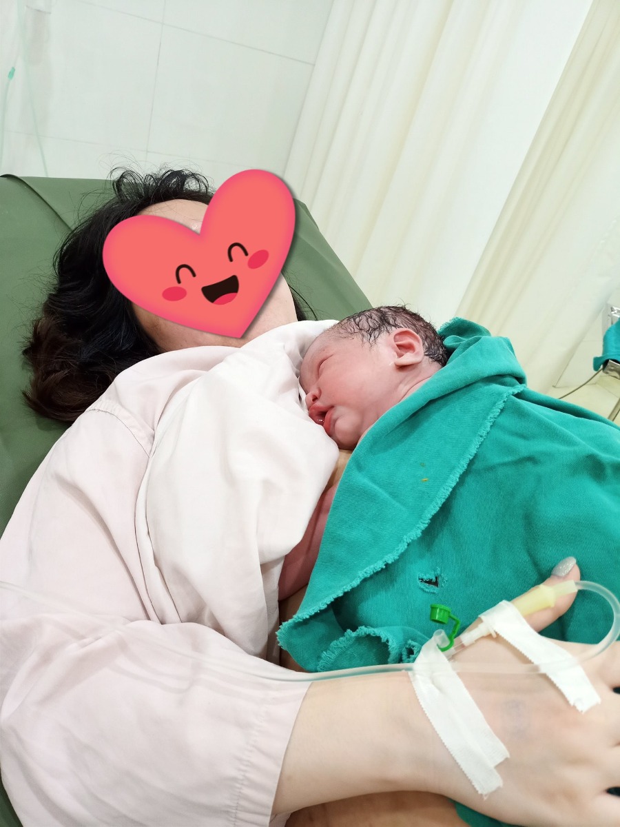 Mình vừa sinh sáng t7 (17/4) ở Bệnh Viện Đa Khoa Hà Đông. Mình sẽ review lại cho các bạn nào còn lăn tăn chưa biết chọn viện nào để sinh, thì theo mình thấy viện Hà Đông xứng đáng là lựa chọn ưu tiên nếu ko có vấn đề j về bệnh lý quá đặc biệt nhé ạ.

Mình sinh lần 2, bé đầu đẻ thường ở sản C. Sản C thì ko dám chê trách j về chuyên môn, chỉ có điều bị cách ly từ lúc bước chân vào viện đến khi đẻ xong. Ngày có 3 mốc thời gian ng nhà vào thăm, mỗi lần được 1 tiếng, đã vào là ko đổi ng được, ra thì ko vào lại được. Ng nhà thăm nom cũng bị hạn chế. Nhà mình lại ít người, nhiều khi rất bất tiện, nên lần này mình chọn phương án khác.

Bạn bè mình ở mạn Hà Đông nhiều nên hội nó có giới thiệu qua khám ở bsi Hùng - 68 Vạn Phúc. Nhưng ban đầu mình cũng chưa đến, vẫn ưu tiên khám bsi sản C và qua cả pk An An (BVien Bưu Điện) - nhà mình ở Thanh Xuân. 

Lúc mình được 20w thì bạn mình đẻ mổ ở HD, kíp mổ có bsi Hùng và bsi Thái. Nó khen bsi Hùng ghê lắm, bsi mổ mát tay, nhẹ nhàng, ko đau, sau mổ thăm hỏi hàng ngày. Nói chung là rất thân thiện, nhiệt tình với bệnh nhân. Sau quả review chân thực đấy mình mới thêm bạn fb với c Trang - vợ a Hùng để đky khám từ mốc 22w.

Ấn tượng đầu tiên là phải đặt lịch sớm (3-5ngày), mốc h khám cụ thể. Lúc đến thực tế mới thấy cách làm việc rất chuyên nghiệp, ko phải chờ đợi lâu, mình đặt h nào chỉ cần đến đúng h đấy là được khám luôn. 

Ấn tượng tiếp theo là phòng khám dễ thương lắm các mẹ ạ, full hồng nha, chắc bà Trang bả ý mê màu hường 🤣🤣🤣 Ấn tượng tiếp nữa là chi phí khám rẻ hơn tất cả những chỗ mình đã từng khám! Hehe. 

Ấn tượng quyết định là nhiệt tình, 2 vợ chồng bác sĩ đều nhiệt tình cực lun ý, chị vợ thì dễ thương, luôn nhớ tên, fb của khách hàng, làm mình cảm thấy kiểu như được trân trọng ấy. Đấy là điểm mấu chốt giữ mình quay lại tất cả các lần sau. 🥰🥰🥰

Khám ở đây thì yên tâm nha các bạn, ko phải lo vào viện kiểm tra làm j cho chật chội, chờ đợi. Đến mốc làm hss a/c cũng hướng dẫn từ A-z luôn ấy

Đến ngày dự sinh chưa thấy có dấu hiệu j, bsi bảo mình vào viện kiểm tra nhưng ctc còn cao với dày, chưa đẻ được mà mình dự kiến sinh thường. Bsi lách ối và bảo về nhà theo dõi thêm. Cứ nghĩ chắc phải tuần nữa mới sinh thì ôi thôi, sáng vào viện, đêm đau đẻ luôn 🤣🤣🤣. 

1,2h sáng đang ngủ thì cơn đau ập đến cứ nghĩ đang nằm mơ, vẫn cố ngủ tiếp. 3h dậy bảo ck là e đau đẻ rồi nhưng theo kinh nghiệm e thấy vẫn chưa dồn dập vs tự dưng sấm chớp đùng đùng xong mưa to, nên là cố ngủ tiếp đến 6h. Gọi cho c Trang bảo c ơi e đau 5p 1 cơn rồi. Bà ý bảo vào luôn đi a Hùng đang trong viện. Thế là bắt taxi vào viện luôn. 6h20 đến viện, a Hùng ktra bảo mở 4p rồi, thay đồ đi rồi lên bàn đẻ luôn! 😅😅😅

Vâng vì lần 1 mình được tiêm giảm đau trước sinh nên đẻ bạn đầu 3kg1 nhẹ nhàng lắm ko đau đớn hay mất sức j mấy. Lần này cũng xin bsi tiêm giảm đau nhưng số đen, vừa lúc ý hết thuốc. Mình khóc nước mắt chảy vào trong. Ekip của mình có c Hoa vs a Hùng đỡ chính. C Hoa động viên bảo yên tâm, c cho m đẻ ko đau ko cần thuốc luôn. Và mình đã đặt trọn niềm tin vào c! 🤣🤣🤣

Nói ko đau thì ko đúng nhưng mà tương đối ko áp lực lắm. Mình đk truyền kích đẻ và a c hướng dẫn, hỗ trợ kèm doạ dẫm nên 6h55 con mình đã tòi ra rồi ạ. 😅😅😅 Nhiều lúc mình bảo úi đau quá cho e nghỉ, thì a c lại bảo thôi nó ko đẻ thường được cho đi mổ. Mình thì nhát ăn dao nghe thấy thế cái sợ quá bảo ấy a c tiếp đi, e dặn bây h đây! 😅😅😅 Tuy hơi đau với mệt nhưng tinh thần vui vẻ kéo lại sức ạ! Hihi. Đẻ thường bị rạch là chắc chắn rồi, c Hoa khâu nhẹ nhàng nên mình chạ có cảm giác gì, lúc ý được ôm con nên cũng sướng. Quên hết mọi thứ.
Mình còn nhờ c y tá chụp ảnh cho lúc đang da kề da vs con. Các c thân thiện lắm ạ, bảo đợi tí cho bé hồng lên chút chụp mới đẹp! 😁 Xong lúc các c lau với mặc đồ cho bé cũng bảo đưa đt đây c chụp cho mấy kiểu. Ui ưng dã man ấy! 🥰🥰🥰

Mình đky phòng 1tr5, 1 mình 1 phòng. Mình đẻ thườg ở 1 ngày mà kiểu ko thik ồn ào nên đky luôn phòng đấy cho thoải mái. Phòng thoáng, mát mẻ, có điều hoà. Vệ sinh sạch sẽ, có tủ lạnh cây nước nóng, giường cho ng nhà đầy đủ. Mỗi tội đêm và sáng sớm hơi ồn. Có nút bấm gọi y tá nếu cần. Phòng ở cuối dãy nên cảm giác có hơi bị lãng quên chút. Mình đẻ t7 nên có vẻ vắng, vắng từ y tá đến sản phụ. Muốn hỏi j bấm ko thấy được toàn phải nhờ chồng đi tìm. 😔 Tìm còn ko thấy mới khổ. Nhắc mãi c y tá trực mới mang kháng sinh cho, tối đau tìm c để nhờ nhét thuốc cũng ko thấy, may sau đấy c vẫn đến nên đêm đỡ đau vết khâu mới ngủ được.

Plasma ko chiếu chủ nhật, mình đẻ sáng t7 nên chiều mới hỏi thì y tá bảo mai ko chiếu, hnay thì chiếu rồi. Lấy máu gót chân thì lại chỉ lấy ngày thường. Nói chung ngoài việc vắng ra thì đẻ t7, cn các dịch vụ ko được ok cho lắm. 

Mình ở đến sáng hôm sau tắm cho bé xong là khăn gói quả mướp đi về thôi. 😁😁😁

Về chi phí, vào viện là ứng luôn 3tr. E dự trù có cả giảm đau và chiếu plasma nhưng ko có cơ hội sử dụng. Bảo hiểm của mình thì cty chưa đóng nên hết hạn coi như ko có bảo hiểm. Mình ra viện cn phòng hành chính họ ko làm viêc, đến mai ck mình mới đi thanh toán thì mình update chi phí nha. 

P/s: quên chụp ảnh cả phòng nên up tạm góc phòng. Phòng giống như trong group các mẹ đã từng up ạ.